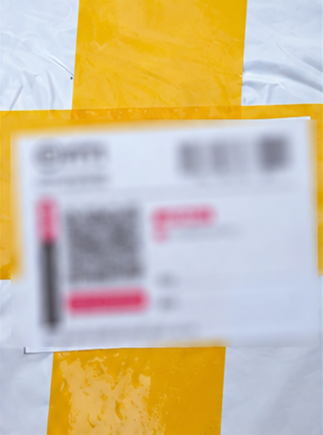 Outer parcel with a blurred delivery label